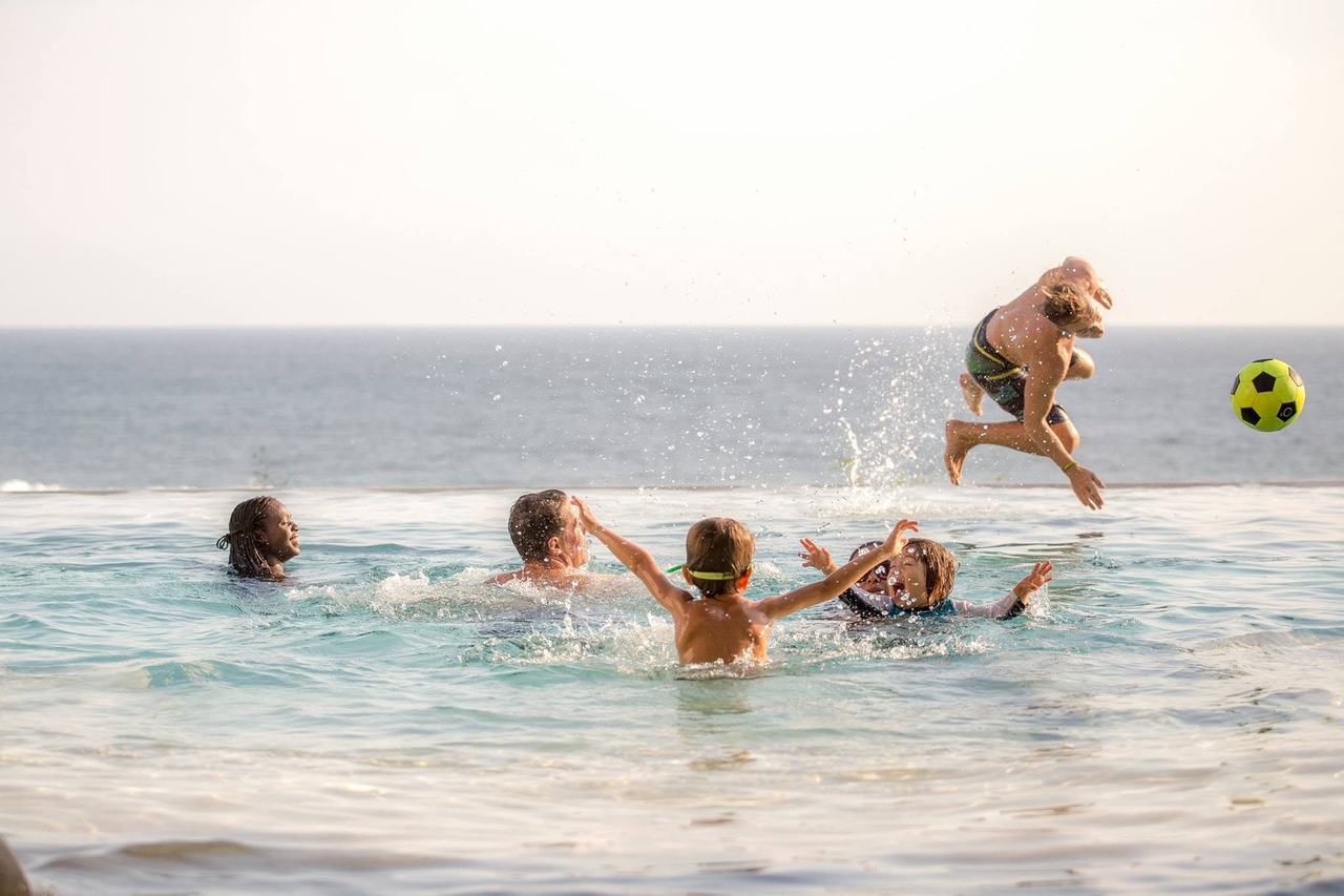 A family playing together in the infinity pool