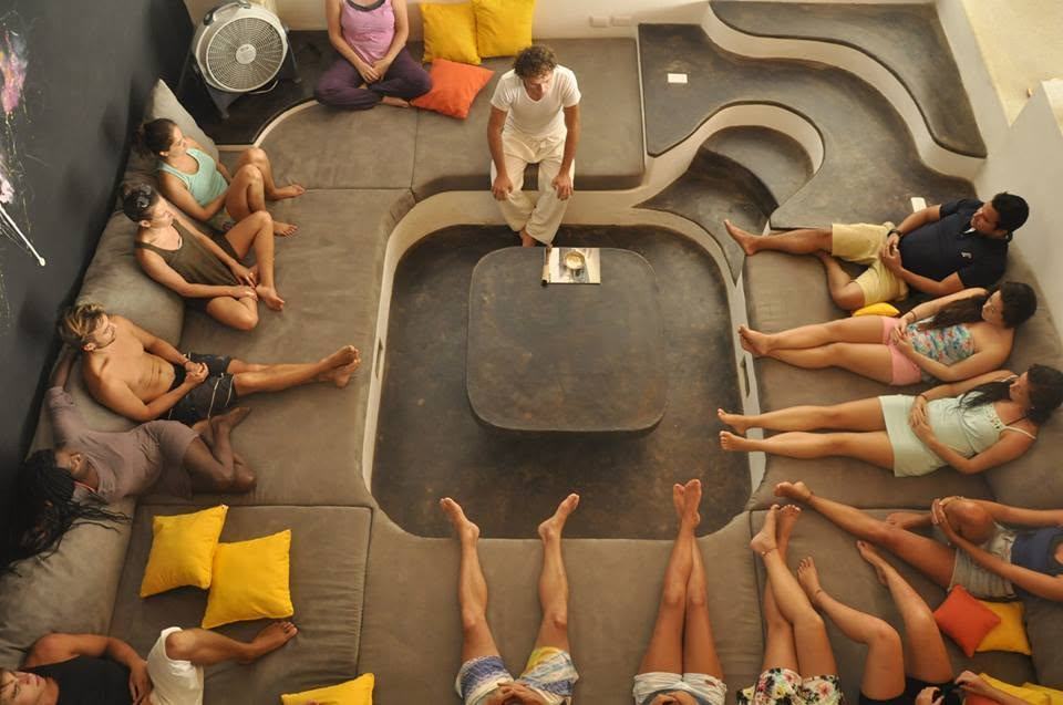 A group gathered in a circle for a session indoors